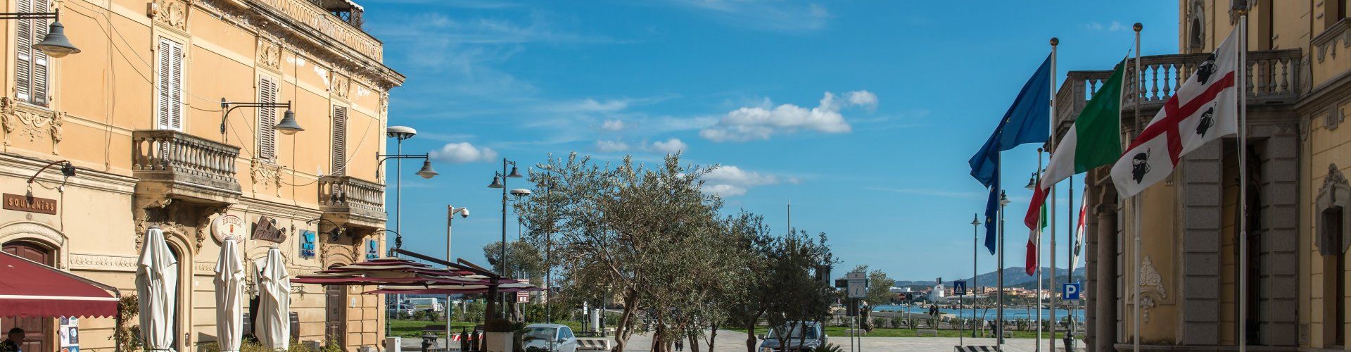 Shopping street Corso Umberto I and view on the harbour of Olbia