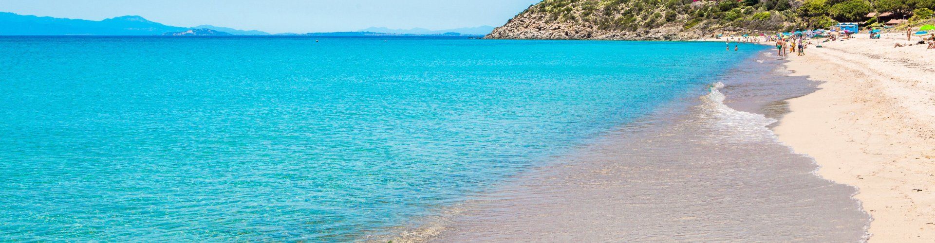 Beach of Geremeas with crystal clear water and Torre delle Stelle in the background