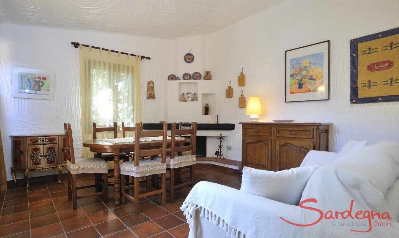 Casa Meloni 1 | Table in the living room with sofa and fire place Dining area