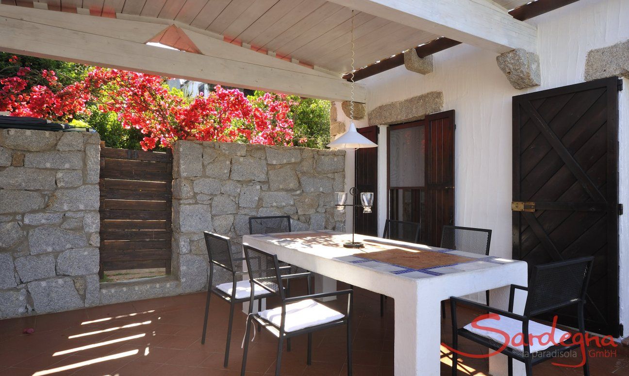 Covered terrace with dining table  