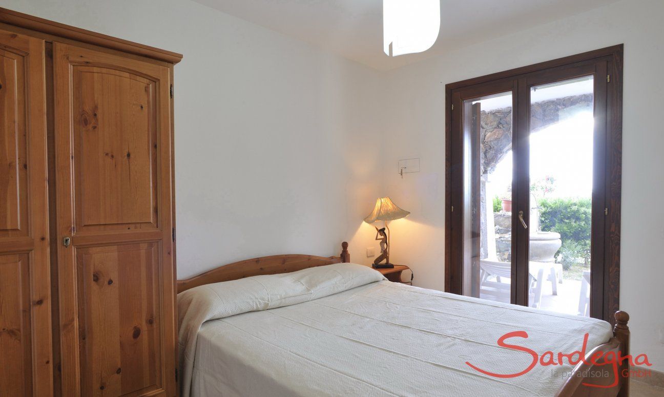 Apartment Castededdu 8 | Bedroom 2 with double sized bed and terrace access Bedroom 2 with double sized bed and terrace access
