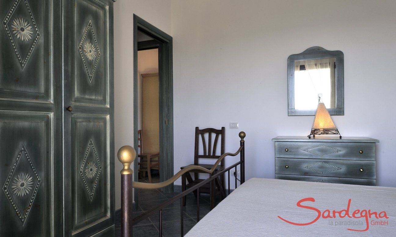 Apartment Castededdu 6 | Bedroom 1 with double sized bed and storage space Sardinia