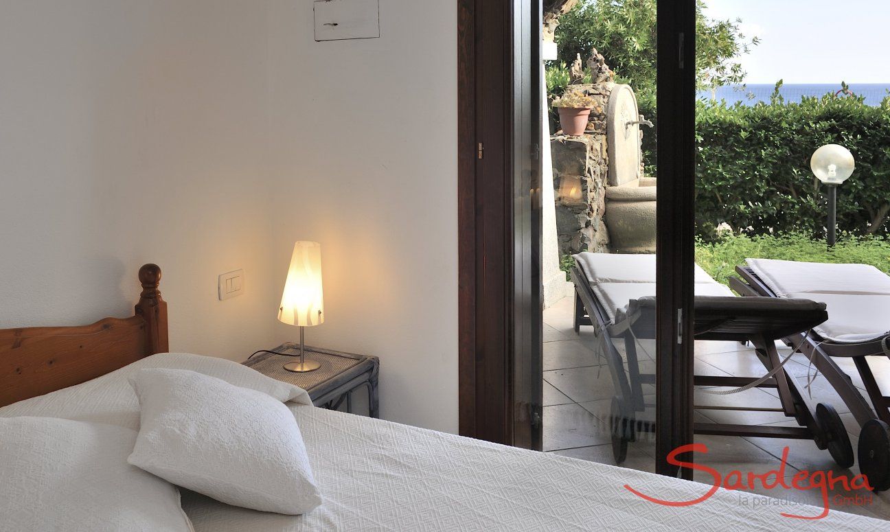 Apartment Castededdu 9 | Bedroom 1 with double sized bed and terrace access Bedroom 1 with double sized bed and terrace access