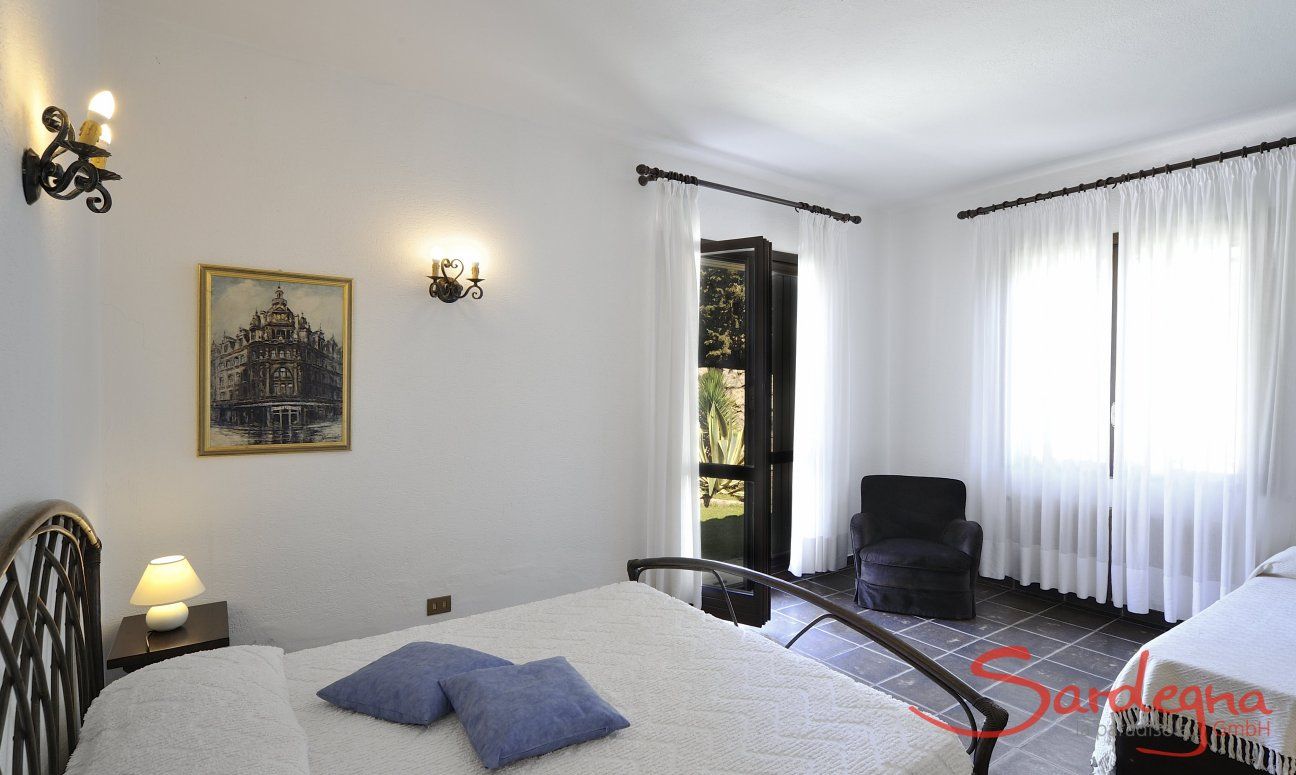 Villa Nautilus | Bedroom 2 with double sized bed, an extra bed and garden access Bedroom 2 with double sized bed, an extra bed and garden access