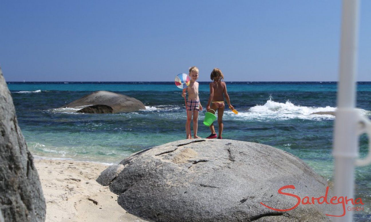 Children on the rocks in the sea of Sant Elmo