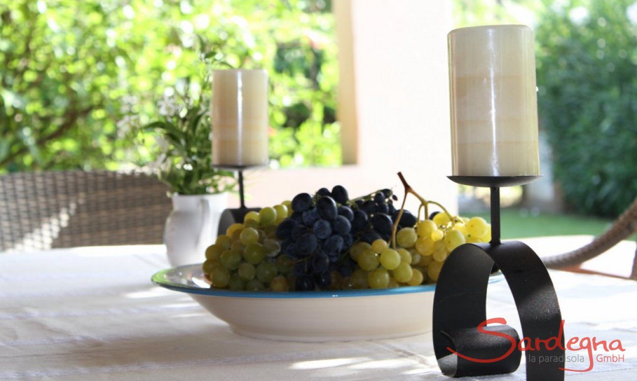 Villa Romana | Table docorated with fresh grapes and candles Sardinia