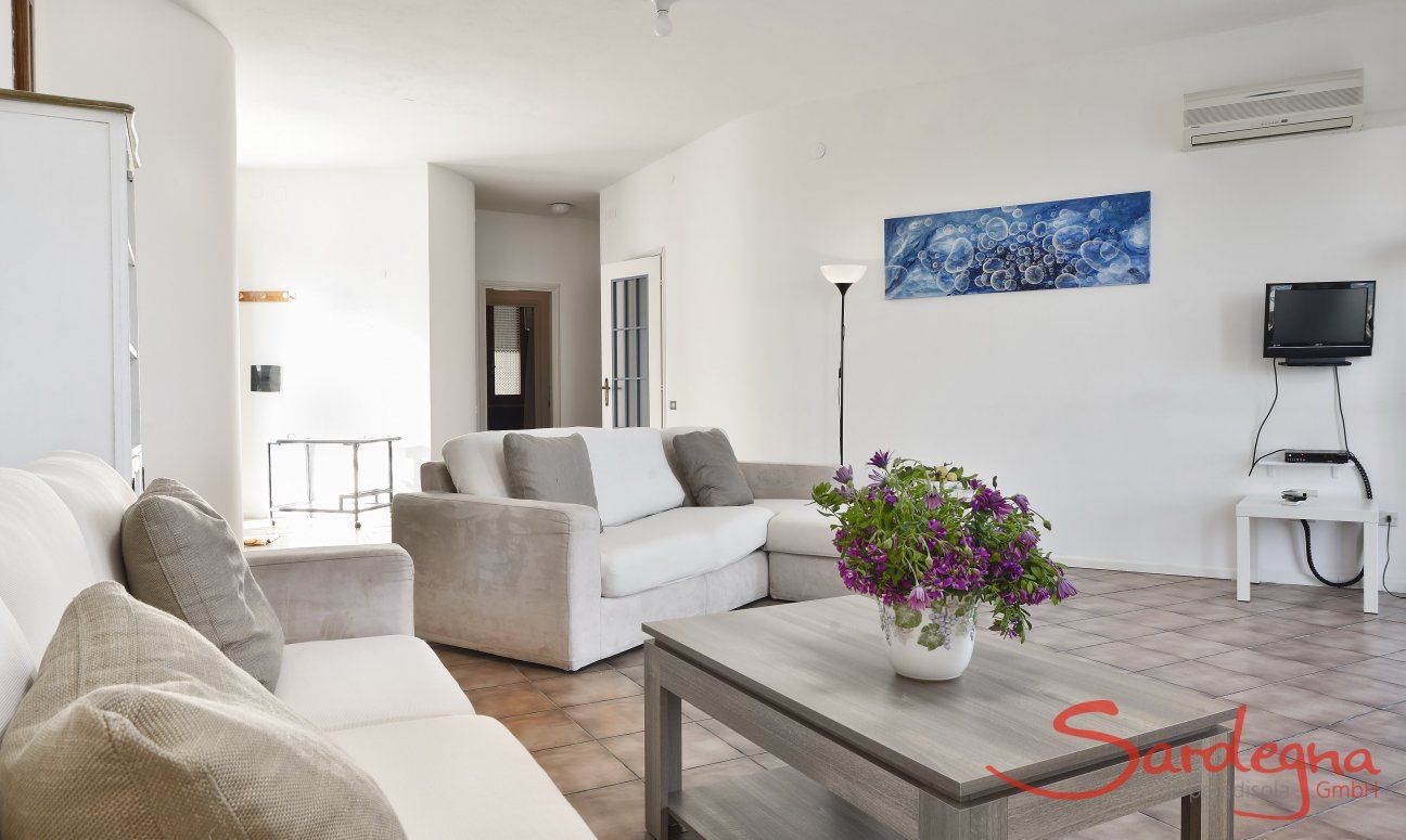 Villa Massidda | Spacious living room with natural light and access to the bedroom area Wide living room with natural light