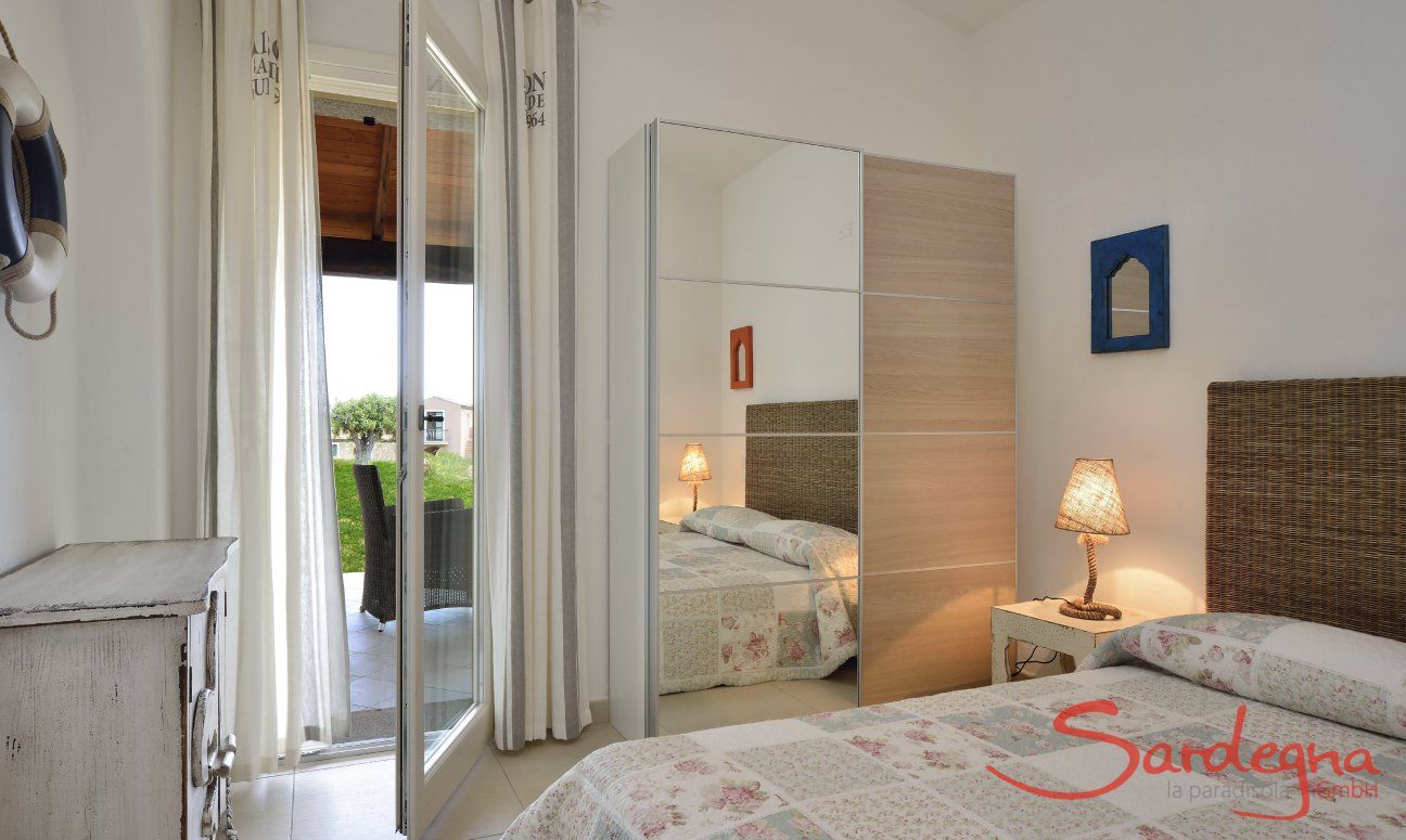 Bedroom with double bed, cupboard and door to the terrace  Villa Campidano 21