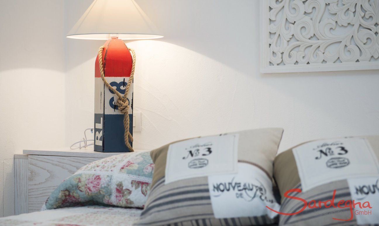 Villa Campidano 21 | Bedroom with mediterranean furniture accessories Bed with cushions, night table and lamp Villa Campidano 21