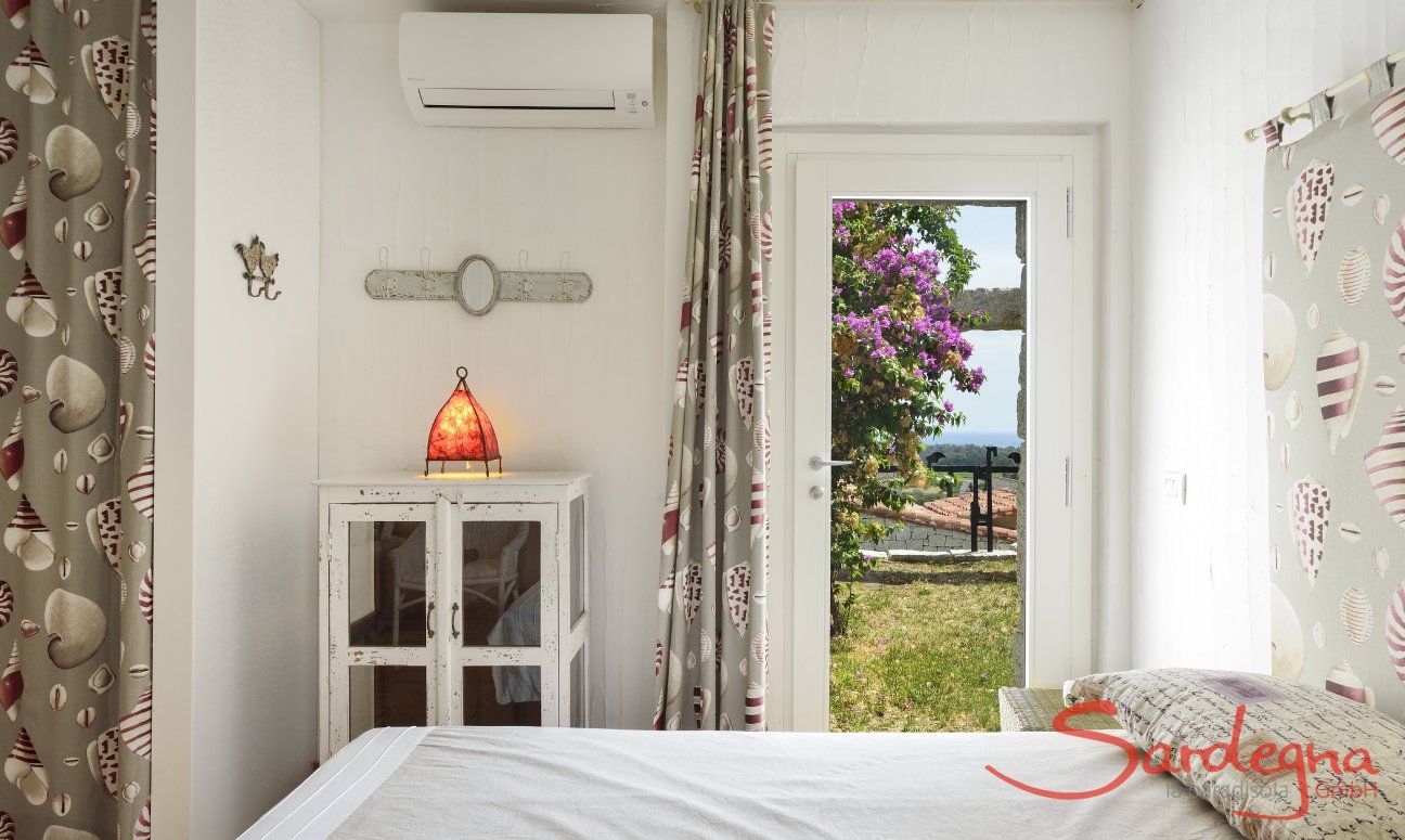 Li Conchi 8 | Bedroom 2 with garden access and double sized bed Bedroom with door to the garden