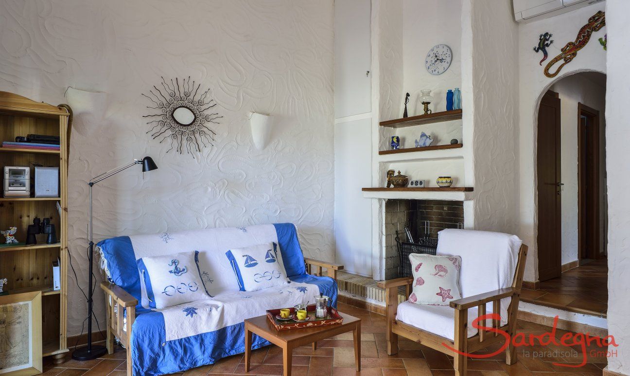Villa Gaia | Living room with sofa corner, fire place and air conditioning Sardinia
