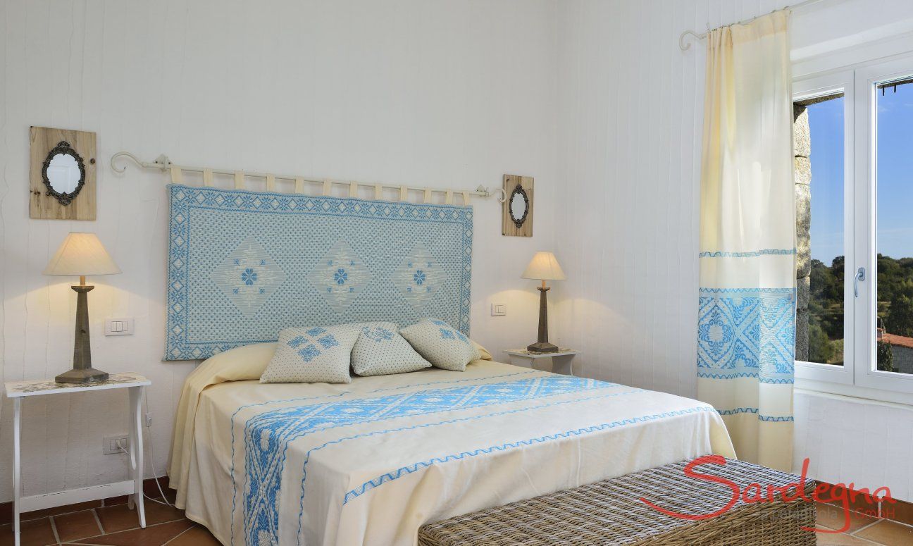 Li Conchi 7 | Bedroom 1 with double sized bed and sardinian decoration Bedroom with double bed and window with garden view, Li Conchi 7