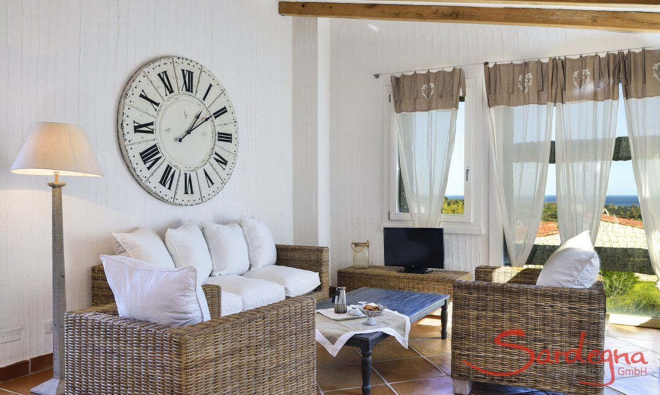 Li Conchi 9 | Sofa corner with sea view Sofa corner with big clock and panoramic window Li Conchi 9, Cala Sinzias