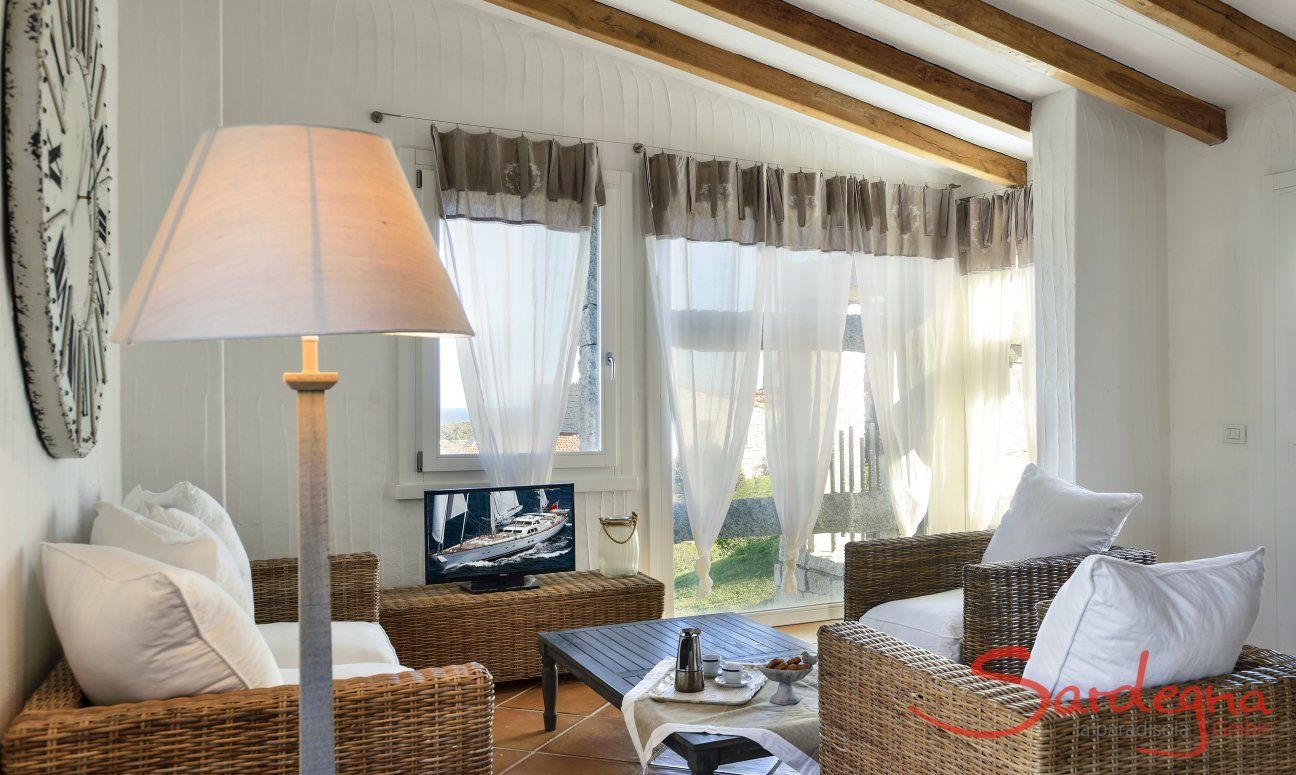Li Conchi 9 | Living room with big panorama window Sofa corner in the living room of Li Conchi 9, Cala Sinzias