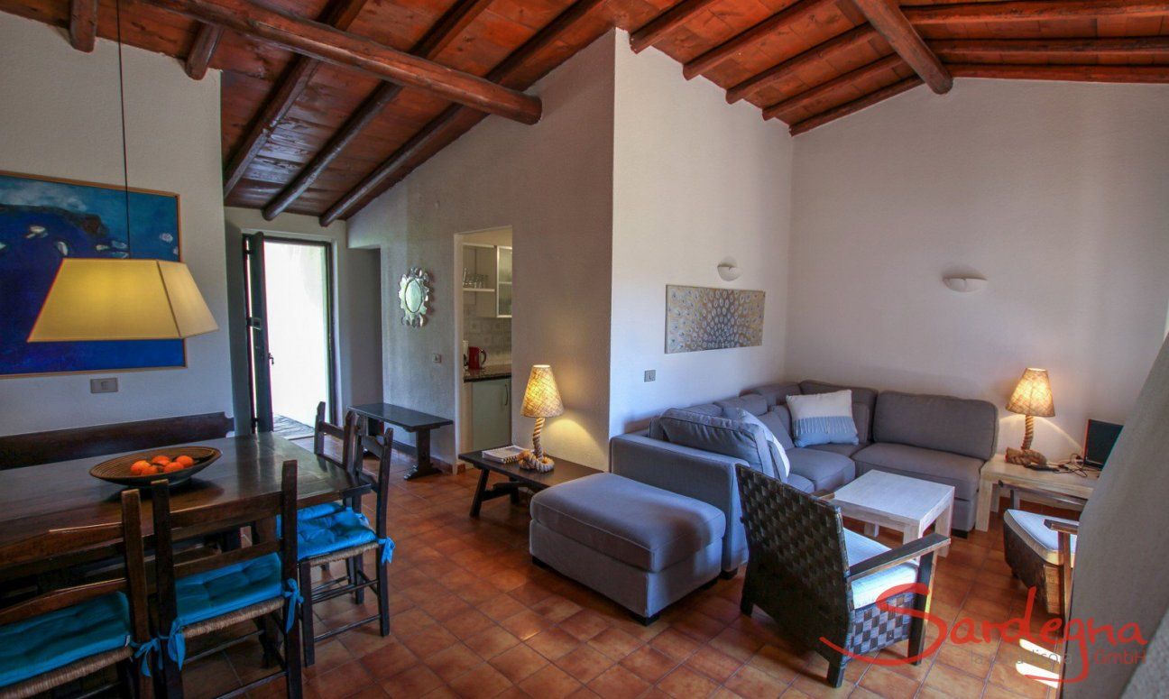 Living area with dining table and a sofa 