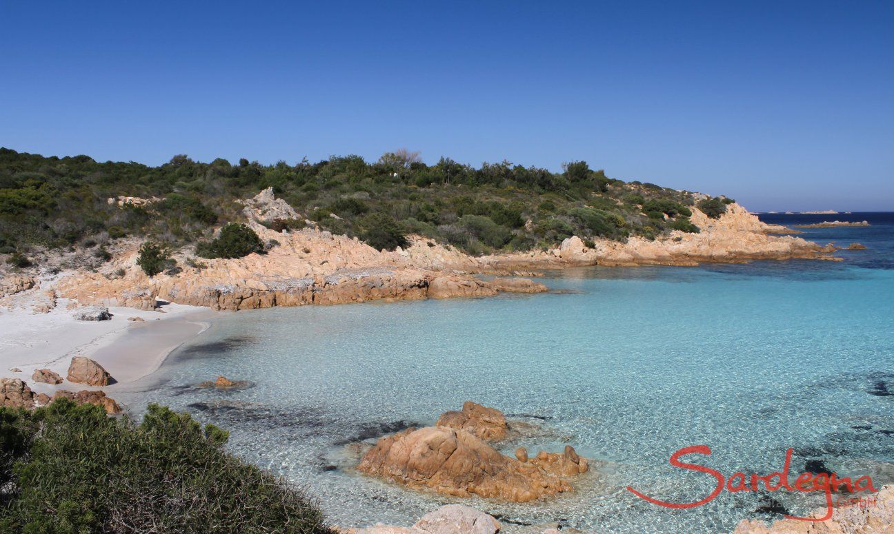 Crystal clear water over the white sandy sea bed of the beach Romazzino