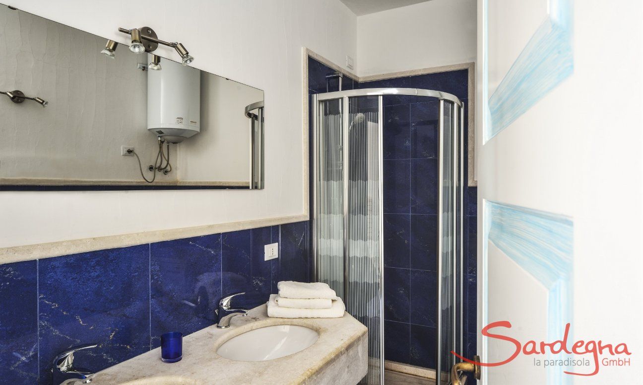 Villa Torretta Chia | Bathroom 3 with shower and two sinks and washing machine Bathroom 2 with shower and two sinks