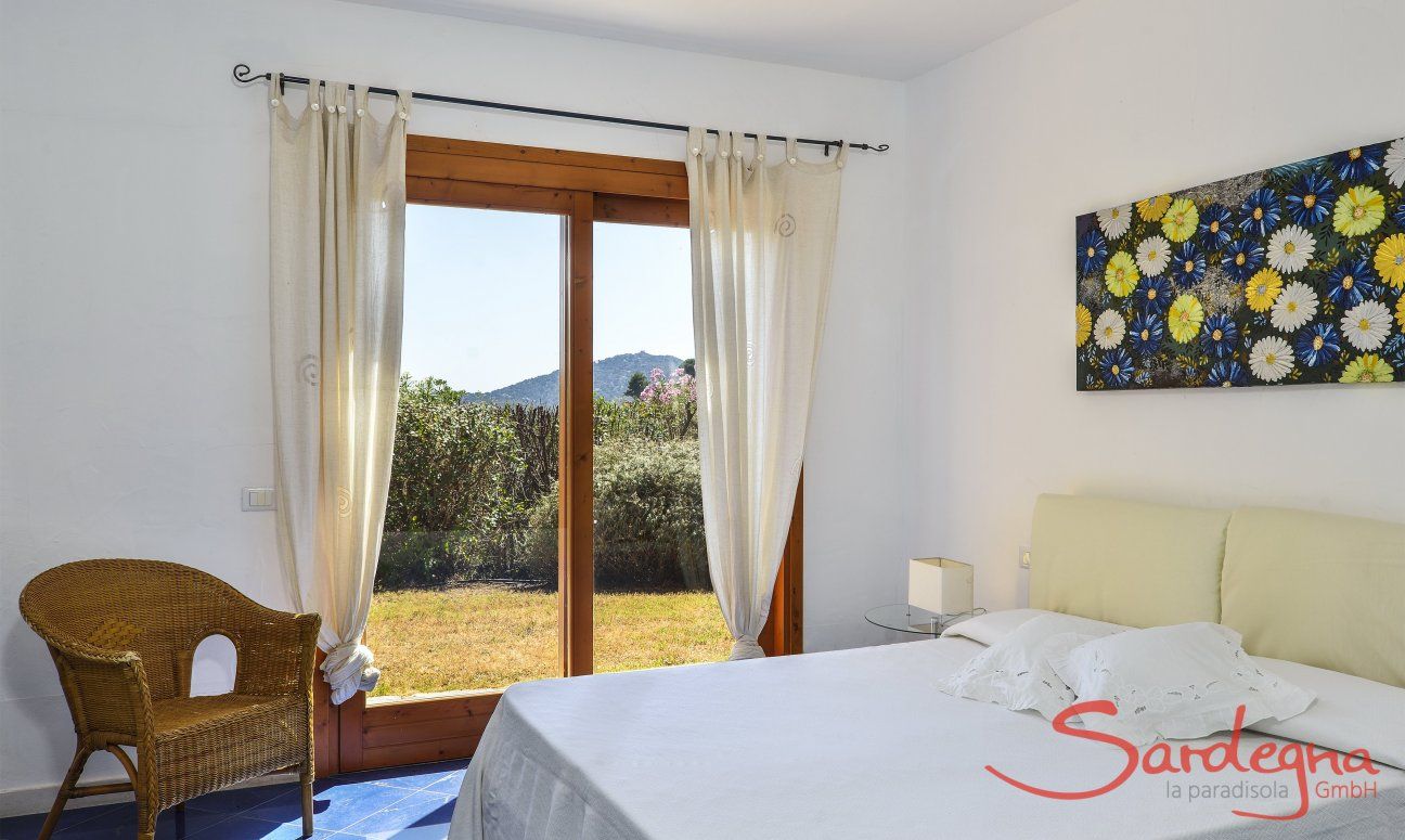 Villa Torretta Chia | Bedroom 1 with double sized bed and garden access and private bath Bedroom 1 with double sized bed and garden access