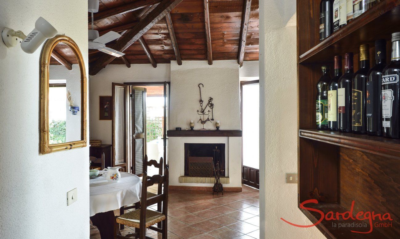 Villa Ibiscus | Living room with dining table and a sardinian chimney Living room with dining table and a sardinian chimney