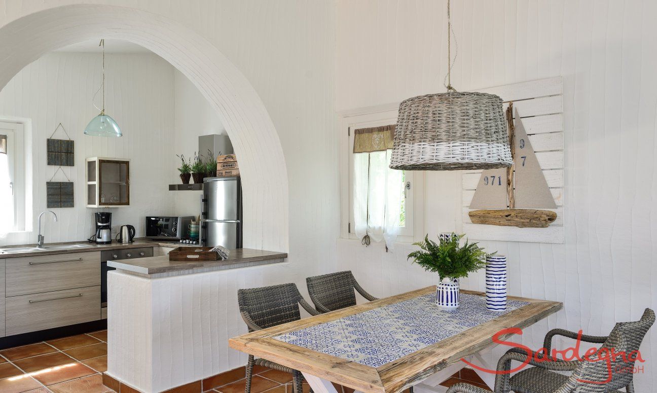 Li Conchi 4 | Dining table and kitchen in the background Dining table with kitchen in the background