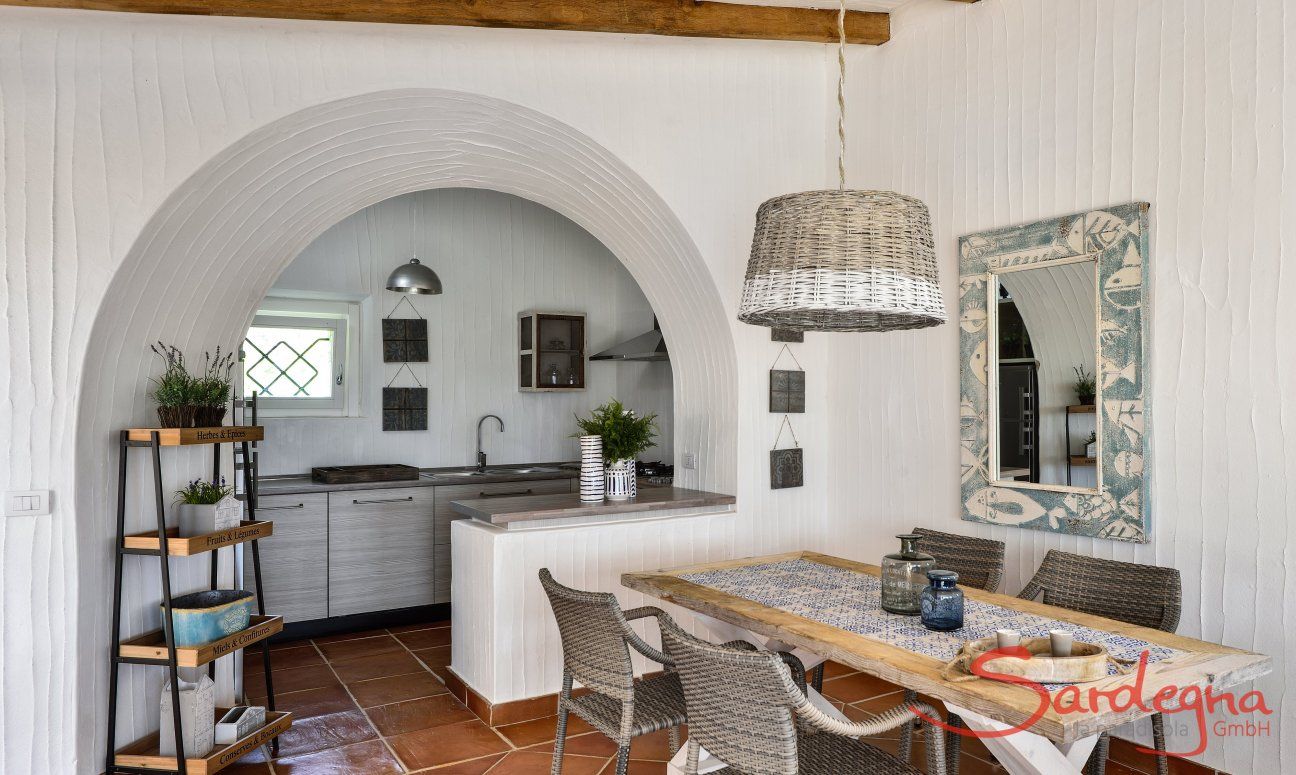 Dining area with kitchen in the background