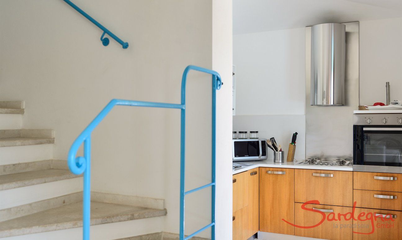 Villa del Campo | Stairs to the first floor and view towards the kitchen Stairs to the first floor and view towards the kitchen