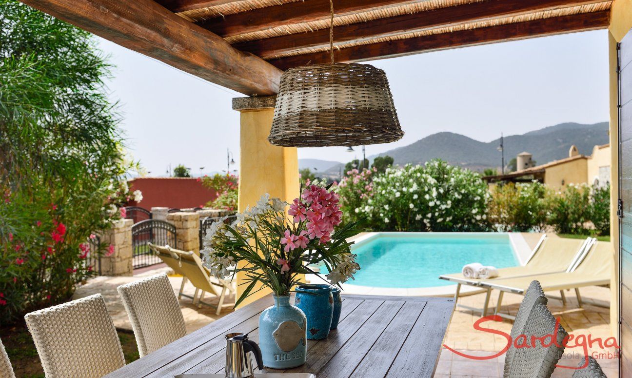 Villa Campidano 8 | Dining table with the pool in the background Dining with view of the Pool