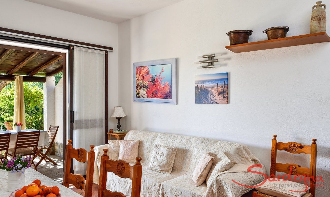 Villa Nicola | Living area with a sofa, dining table and terrace access Living area with a sofa, dining table and terrace access
