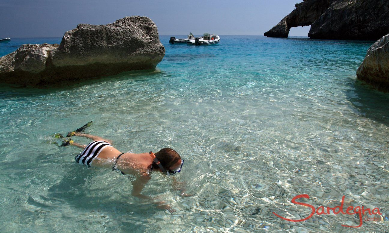 Young girl snorkelling in the transparent water of Cala Goloritze