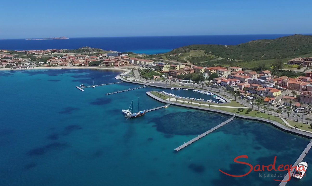 Airview of Golfo Aranci with boadwalk along the harbour an white beach