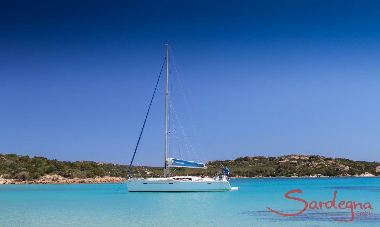 Sailing boat floating on the crystal clear water of Cala di Volpe