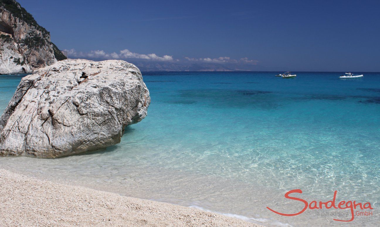 Big, white round rock in the crystal clear water in front of the beach of Cala Goloritze