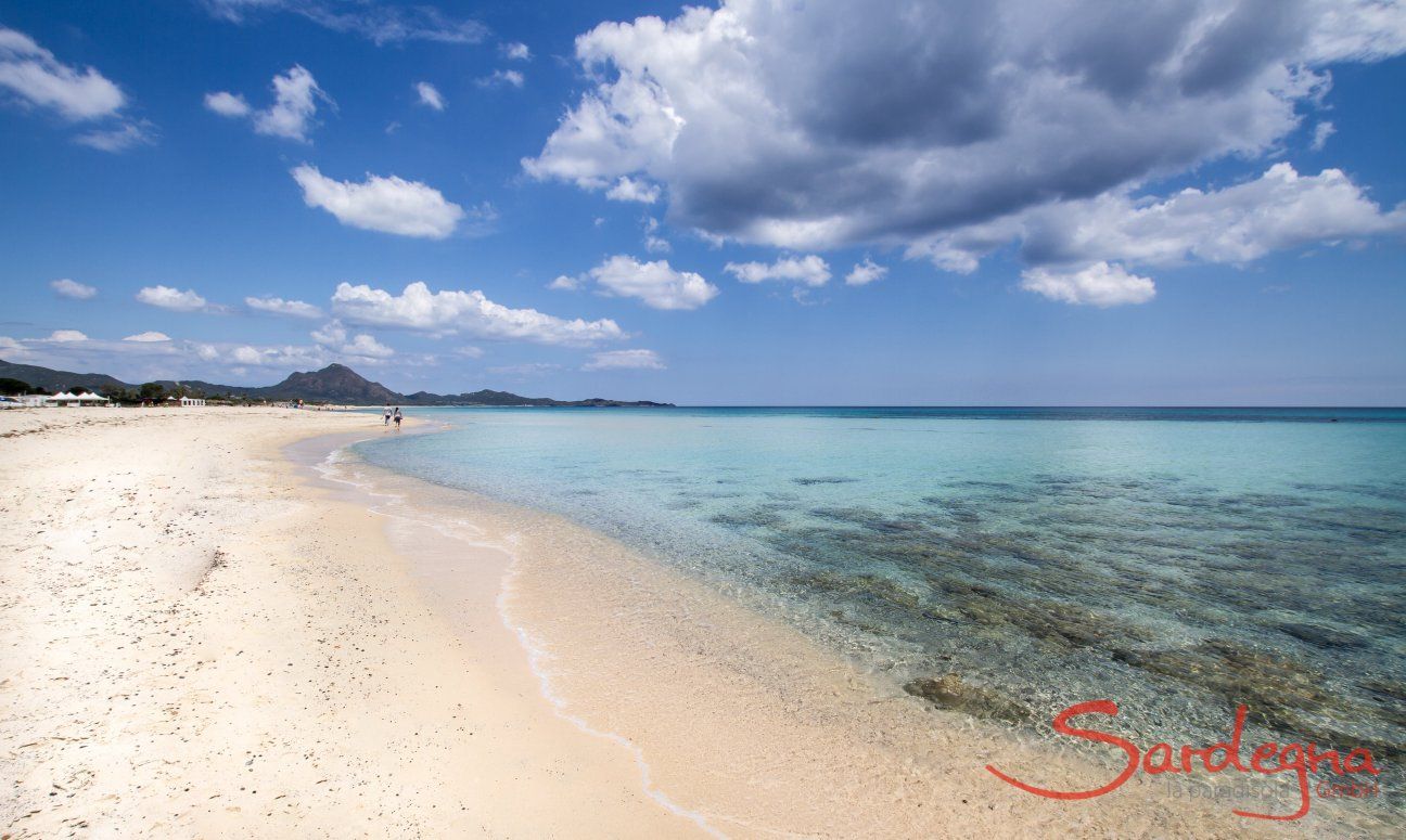 Clear blue water and a white sandy beach 