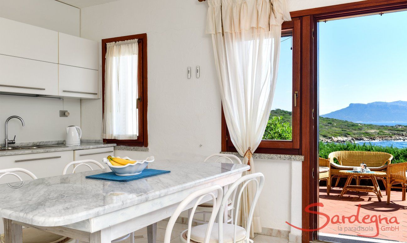 Dining table inside with sea view 