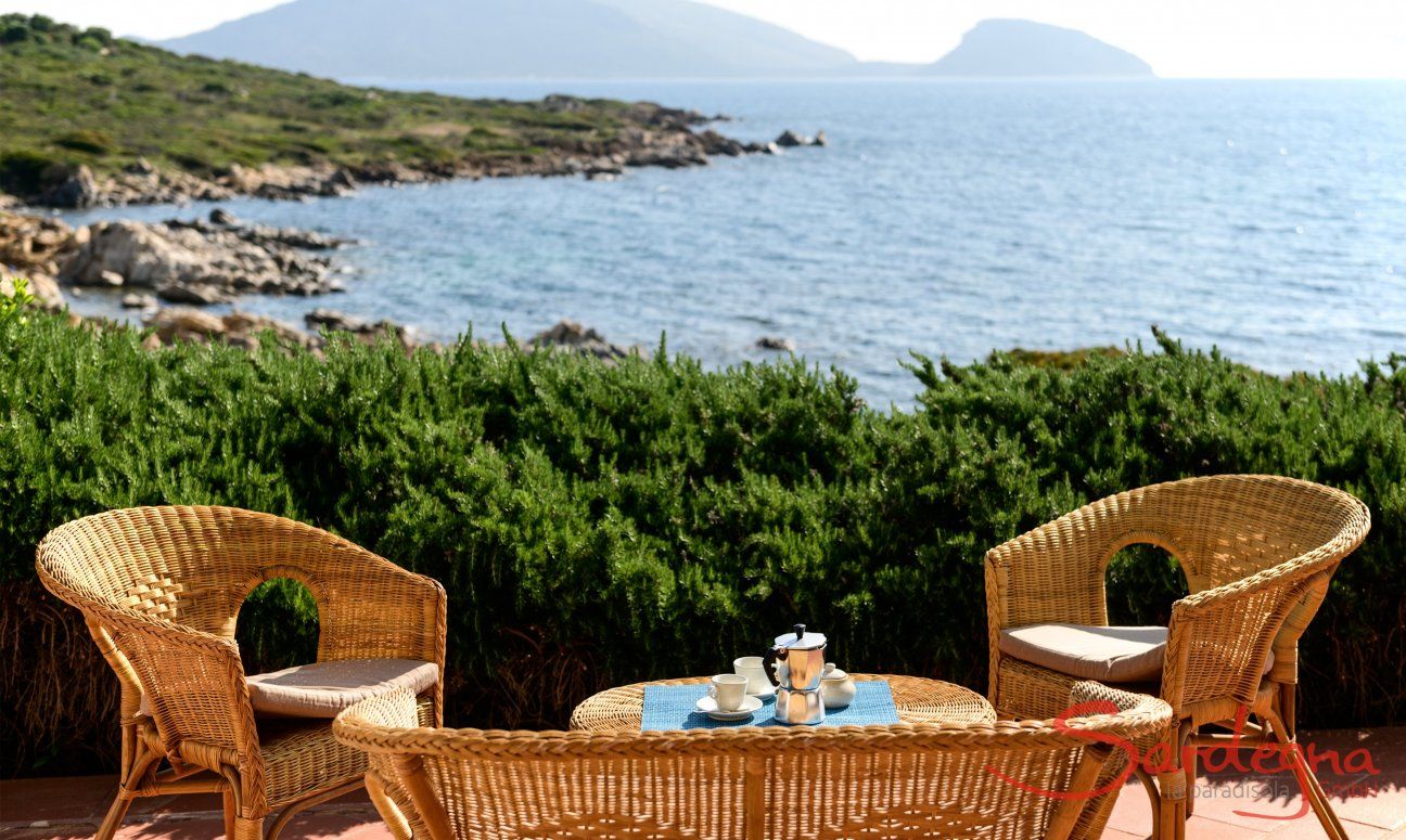 Terrace of the Villa Nodu Pianu with wicker furniture and sea view