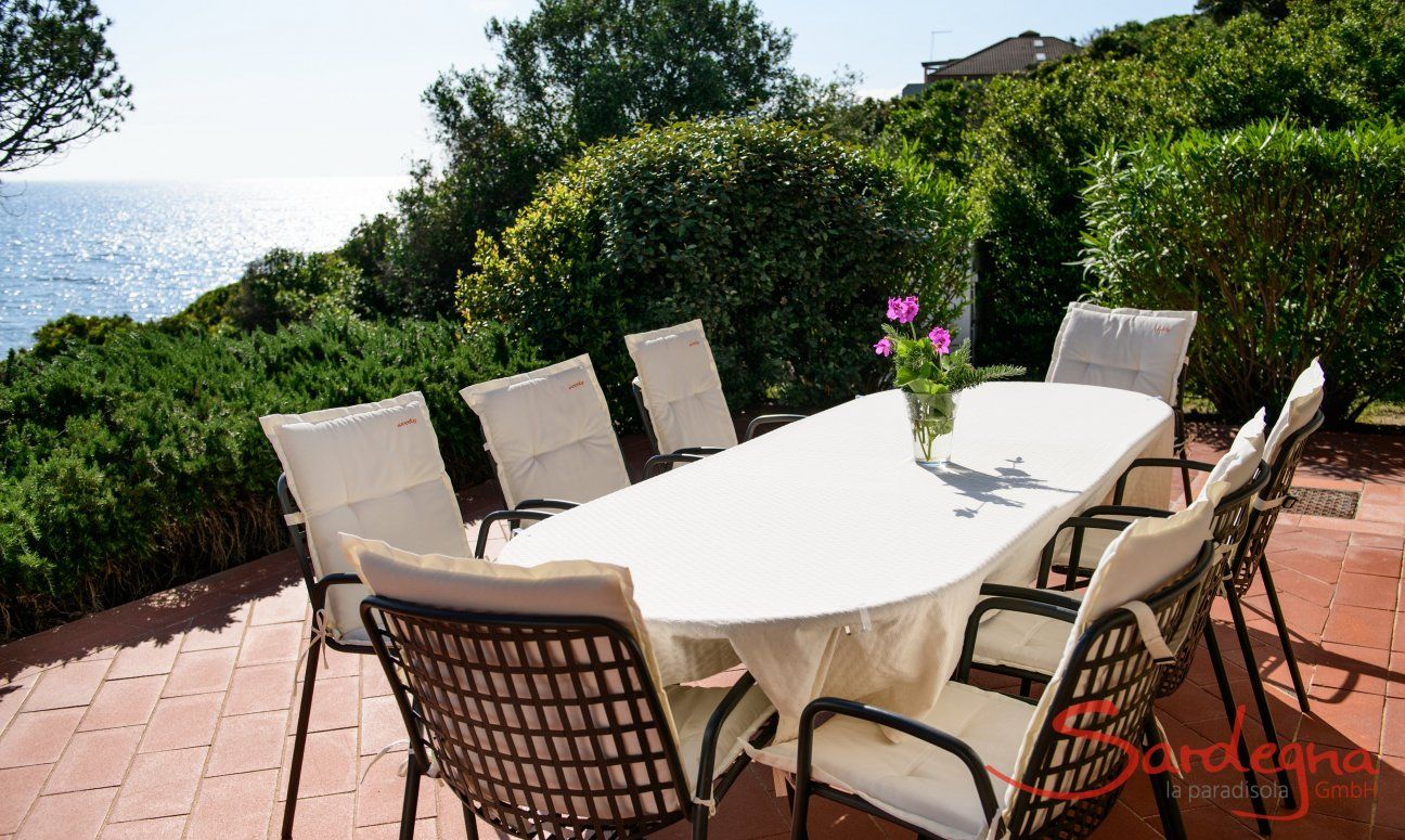 Dining table outside with sea view 