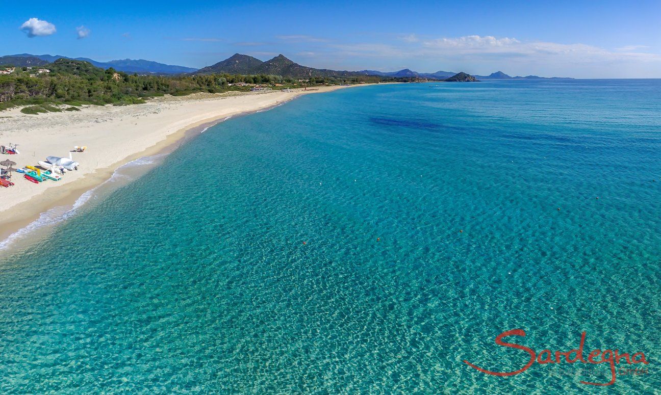 Arial view of the beach and crystal clear water of Cala Sinzias, only about 1.5 miles from Li Conchi