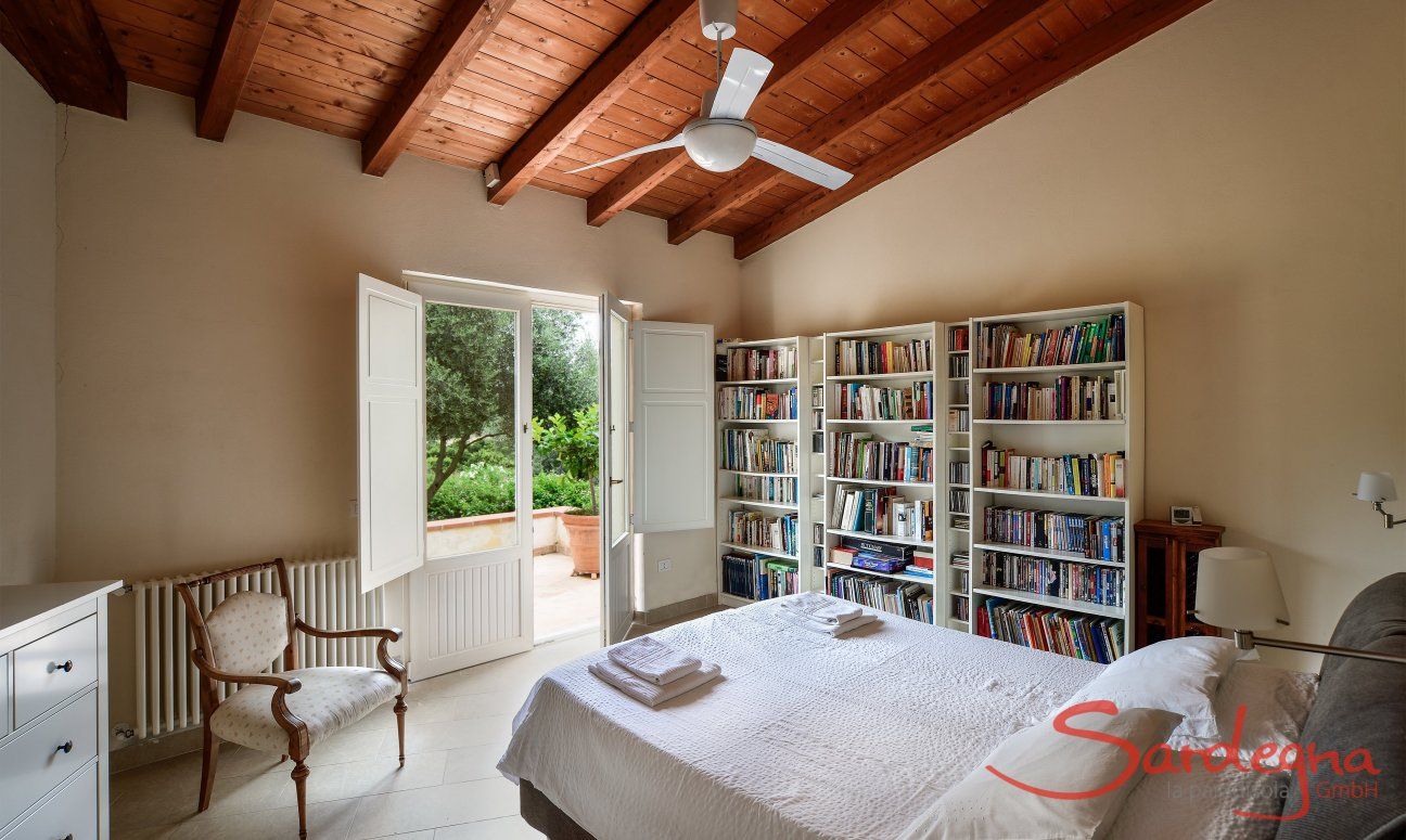Villa Caroline | Bedroom 1 with double sized bed and view across the garden Bedroom 1 with double sized bed and view across the garden