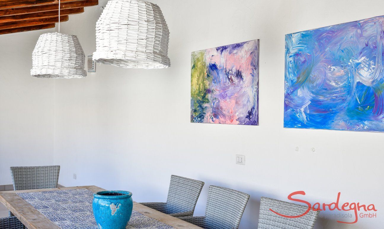 Outside dining area decorated with white lamps and painting in  Villa Campidano 20