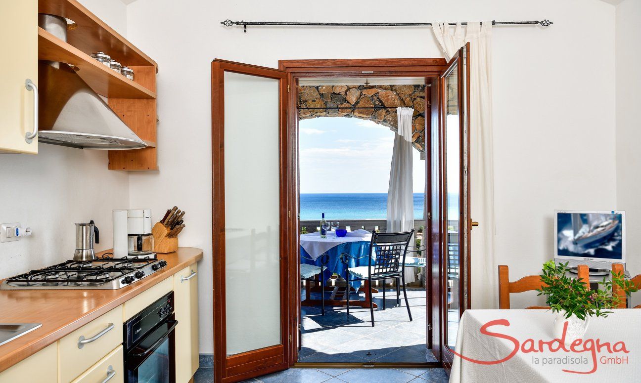 Apartment Castededdu 5 | Kitchen with terrace access and sea view Kitchen with terrace access and sea view