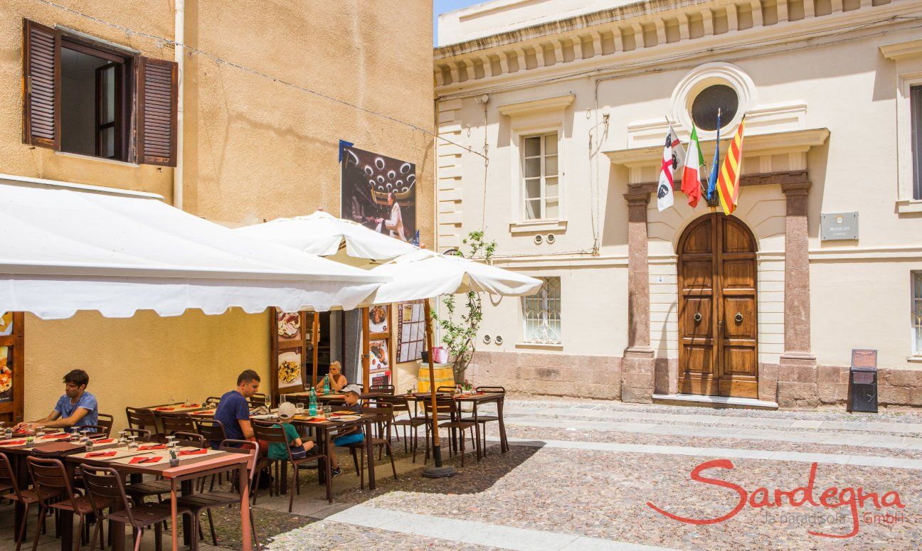 The city hall of Alghero with the sardinia, italian, european and catalan flag