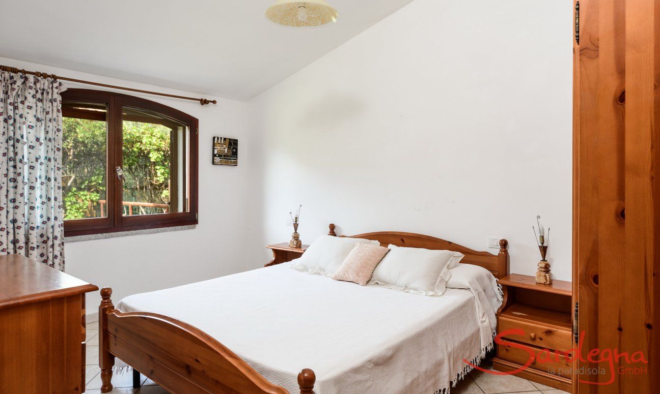Villa Le Ginestre 1 | Bedroom 2 upstairs with one double bed and window with garden view Bedroom 2 upstairs with one double bed and window with garden view