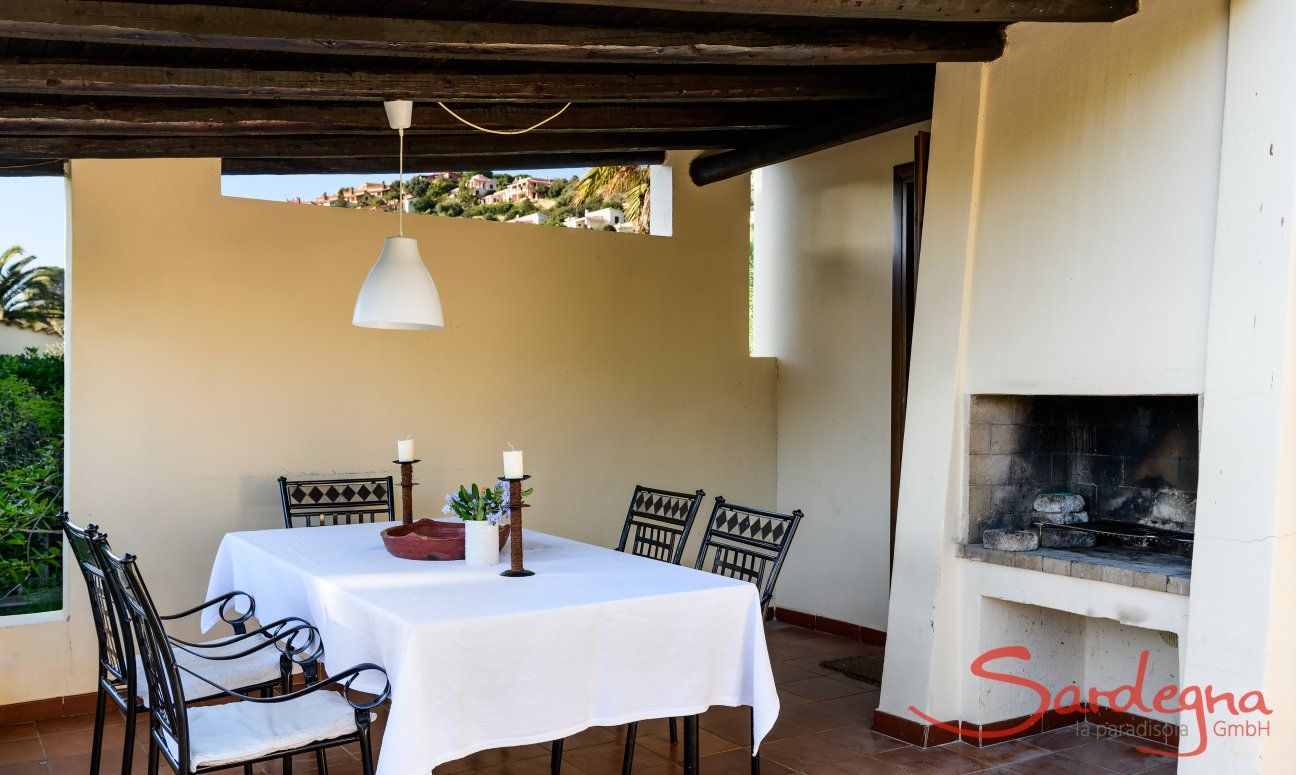 Terrace with dining table and outdoor chimney 