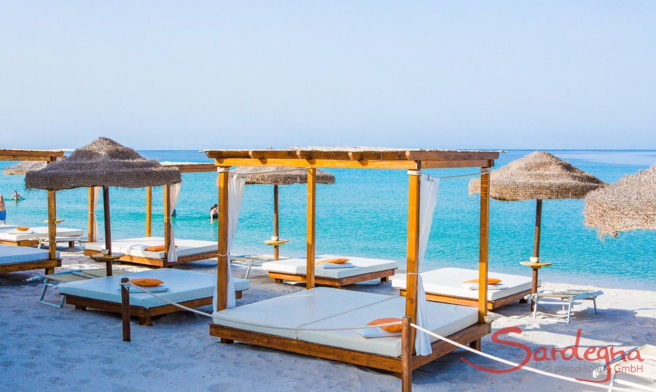 Luxurious sunbeds and parasols on the beach Maria Pia close to Alghero