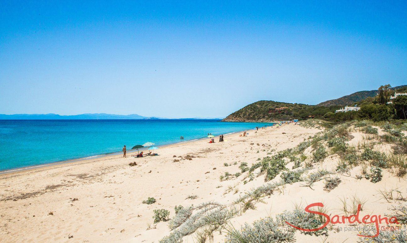 Large white, sandy beach of Geremeas with blue sea and coastline of Cagliari