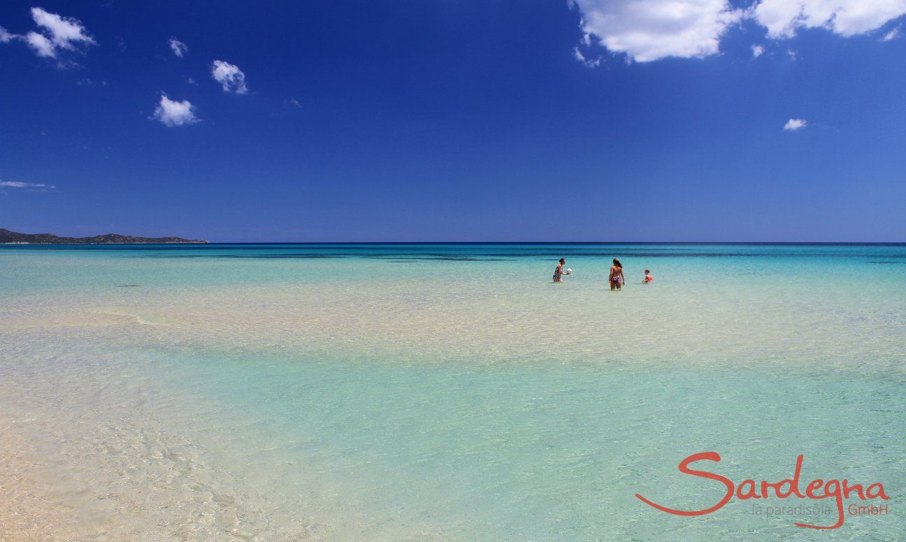 People bathing in the crystal clear sea of Cala Sinzias