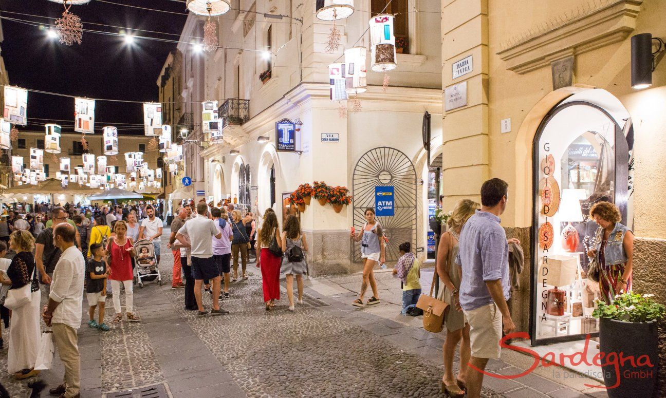 Alghero by night: Crowded streets decorated and illuminated with artistic lanterns