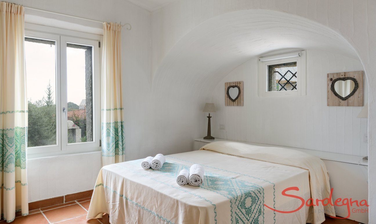 Li Conchi 30 | Bedroom 1 with double bed and window with garden view Presentation of Li Conchi 30