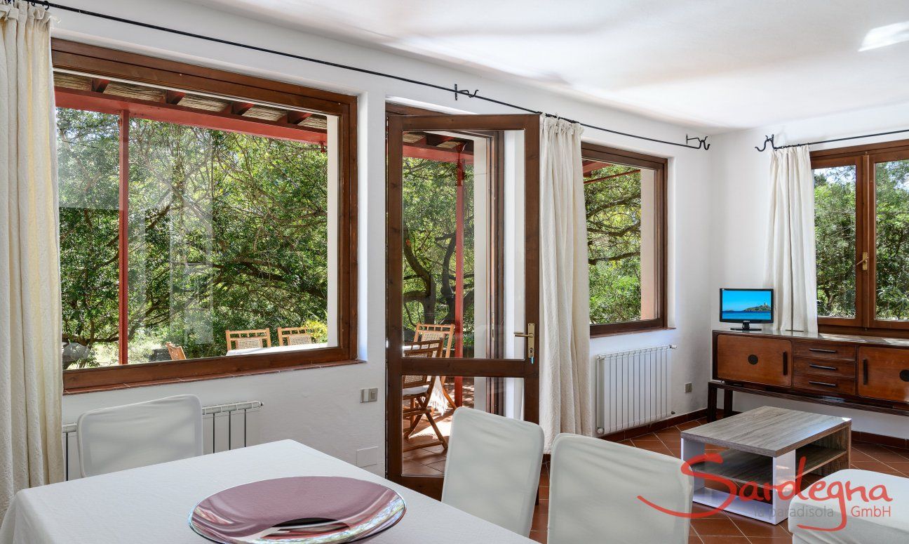 Casa Su Faru 2 | Big window with view into the green bushes from the living room Big window with view into the green bushes from the living room of Su Faru 2 Pula