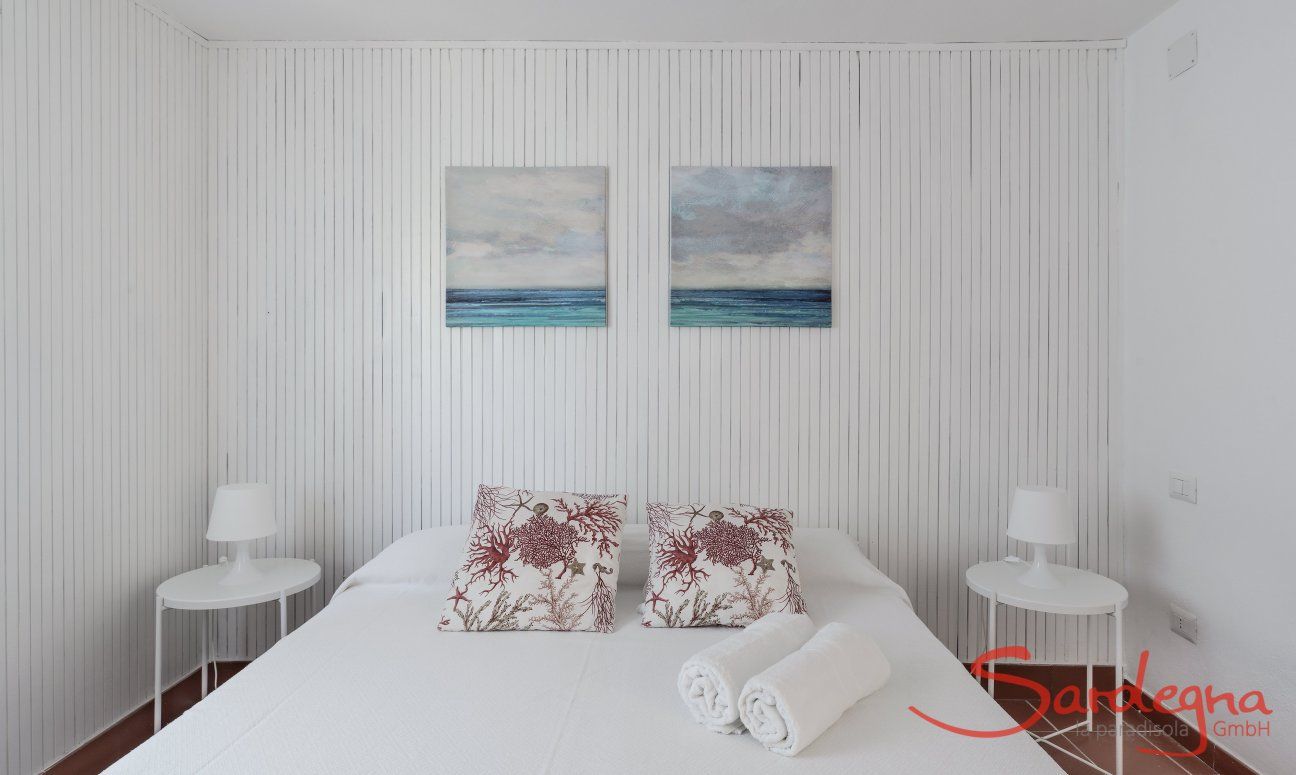 Casa Su Faru 3 | Bedroom 1 with double bed furnished in light, white colours Double room Su Faru 3 Pula